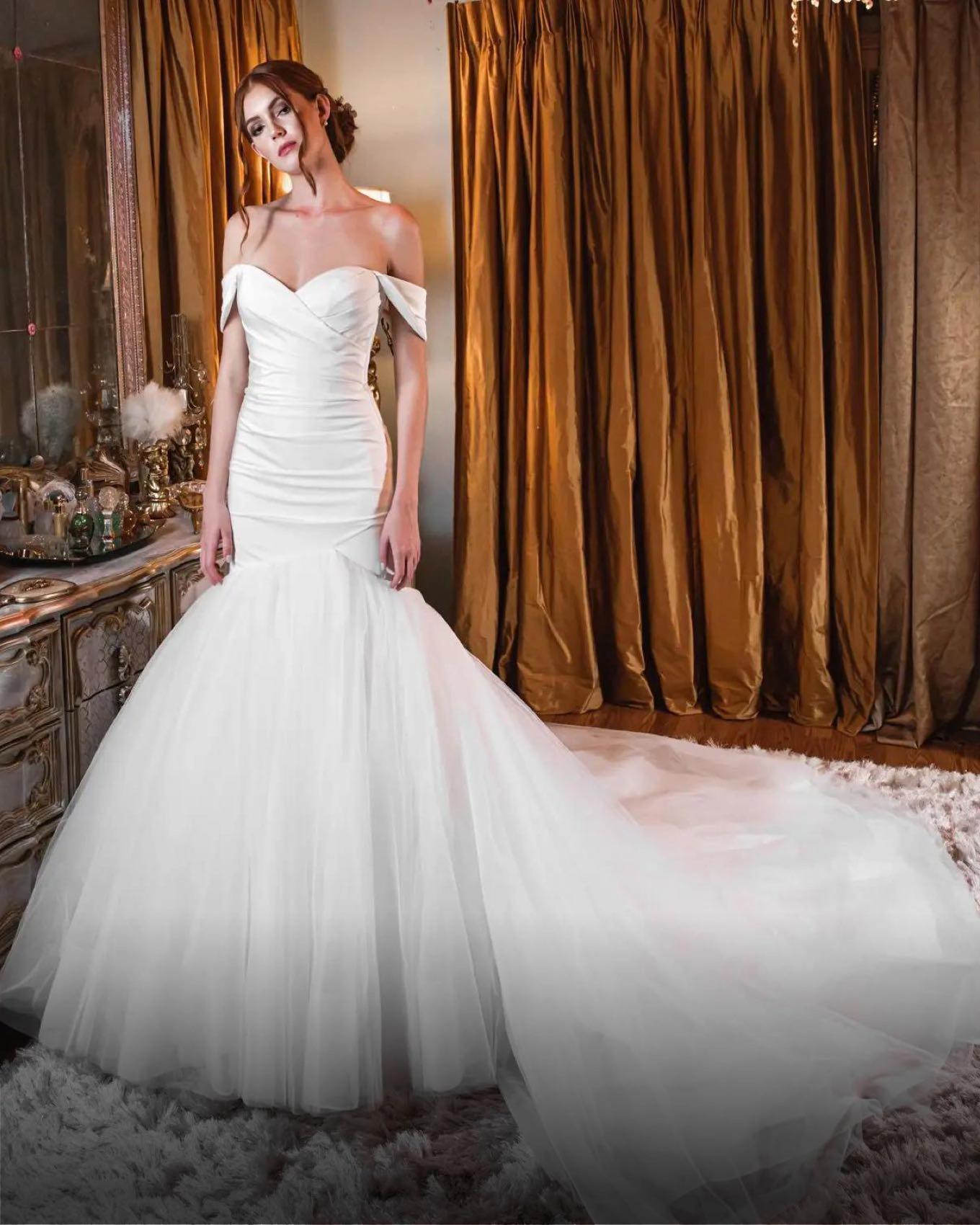 Model wearing a white gown by Mermaid, Orlando bridal shop